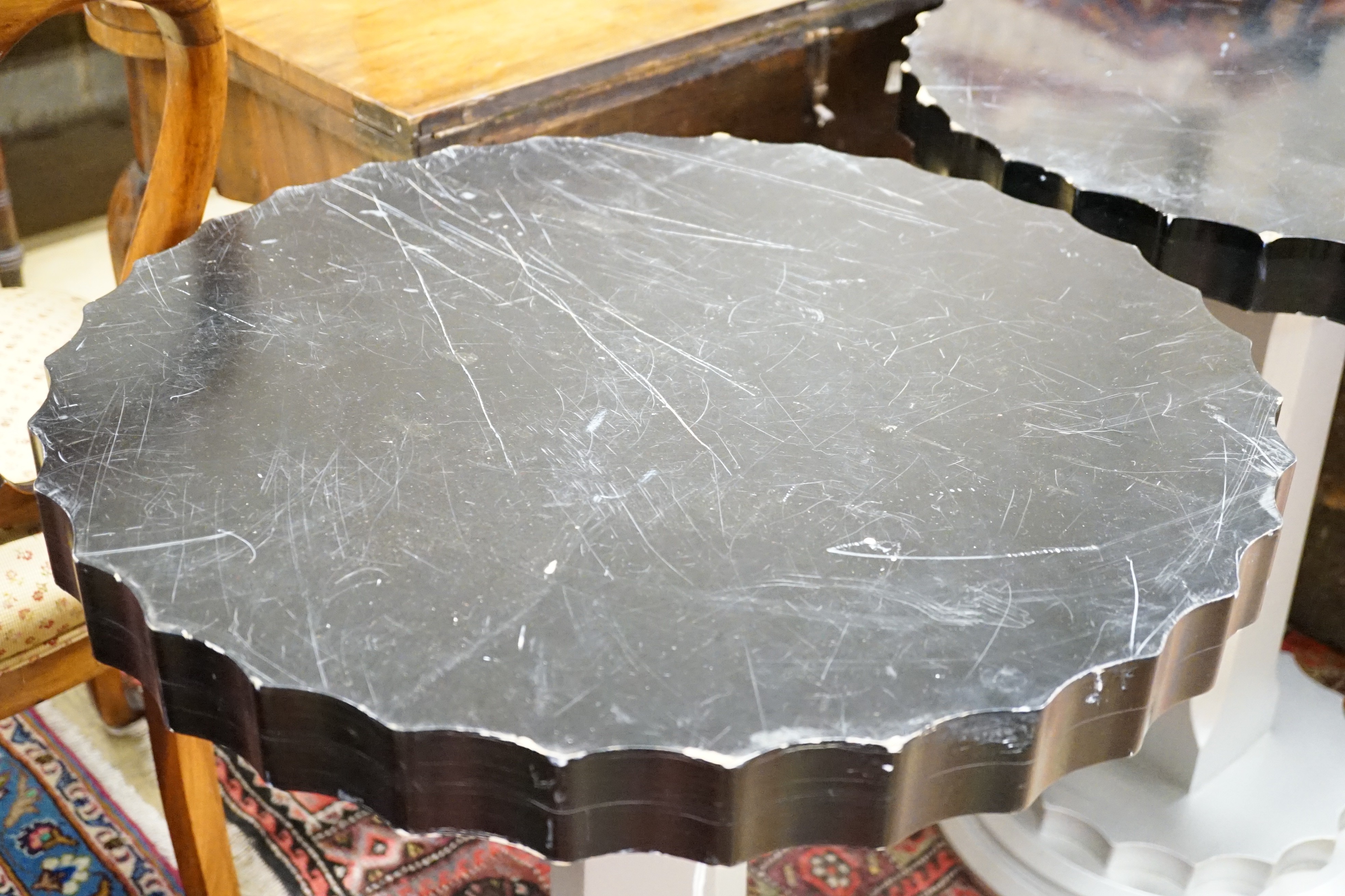 A pair of Art Deco ebonised and silvered wood occasional tables, diameter 60cm, height 71cm